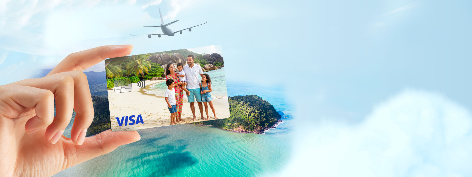 A card in hand depicting a family, with the ocean in the background and an airplane in the sky