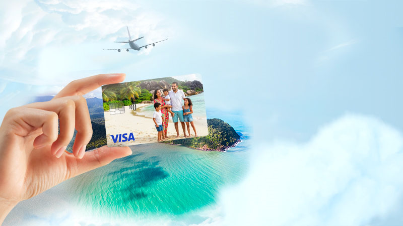 A card in hand depicting a family, with the ocean in the background and an airplane in the sky.