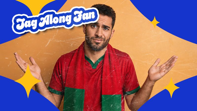 Man with a puzzled expression wearing a red and green scarf, arms raised slightly. Background features blue and yellow shapes with "Tag Along Fan" text.
